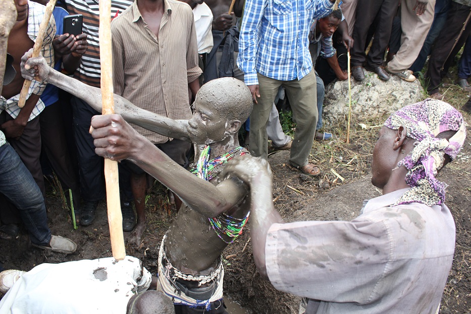 Gidudu is smeared by mud at the Black mud swamp