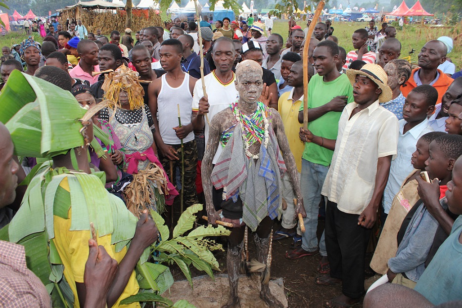 Gidudu stands ready on the second day of the Millet yeast smearing ceremony