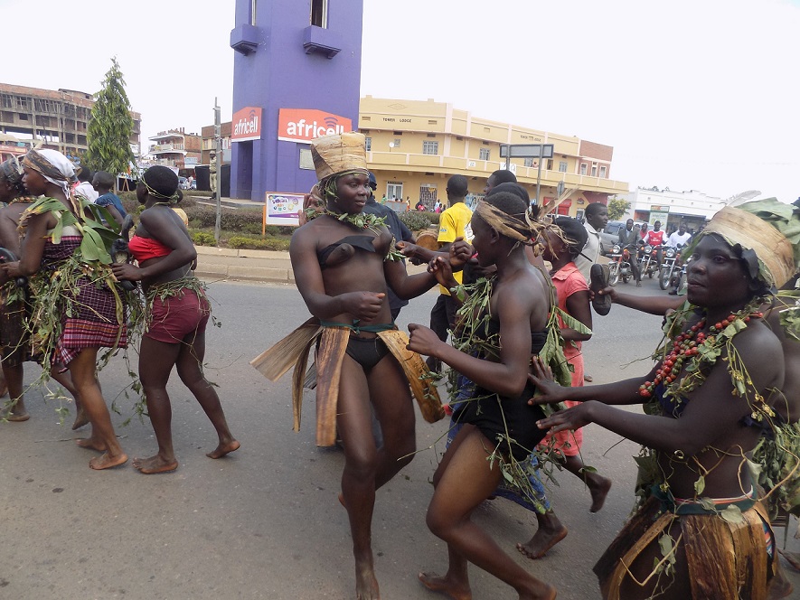 Some of the Parade participants from the Hugu enjoy a moment as the parade moves through Mbale town
